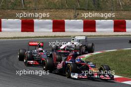 22.05.2011 Barcelona, Spain,  Sébastien Buemi (SUI), Scuderia Toro Rosso, STR06 leads Jenson Button (GBR), McLaren Mercedes - Formula 1 World Championship, Rd 05, Spainish Grand Prix, Sunday Race