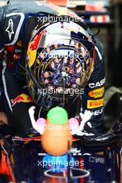 08.07.2011 Silverstone, UK, England,  Sebastian Vettel (GER), Red Bull Racing with a helmet with his pit crew and Mr. potato head - Formula 1 World Championship, Rd 09, British Grand Prix, Friday Practice