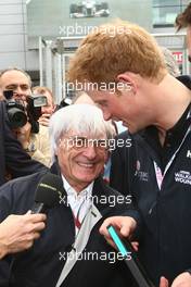 10.07.2011 Silverstone, UK, England,  Bernie Ecclestone (GBR) hands Prince Harry a F1 pass - Formula 1 World Championship, Rd 09, British Grand Prix, Sunday Pre-Race Grid