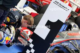 31.07.2011 Budapest, Hungary,  Sebastian Vettel (GER), Red Bull Racing has a close look at the Mclaren in parc ferme - Formula 1 World Championship, Rd 11, Hungarian Grand Prix, Sunday Podium