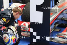 31.07.2011 Budapest, Hungary,  Sebastian Vettel (GER), Red Bull Racing has a close look at the Mclaren in parc ferme - Formula 1 World Championship, Rd 11, Hungarian Grand Prix, Sunday Podium
