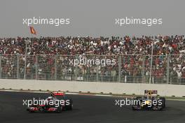 30.10.2011 New Delhi, India,  Jenson Button (GBR), McLaren Mercedes and Mark Webber (AUS), Red Bull Racing  - Formula 1 World Championship, Rd 17, Indian Grand Prix, Sunday Race