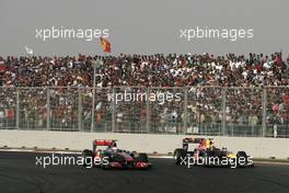 30.10.2011 New Delhi, India,  Jenson Button (GBR), McLaren Mercedes and Mark Webber (AUS), Red Bull Racing  - Formula 1 World Championship, Rd 17, Indian Grand Prix, Sunday Race
