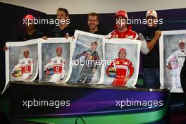 07.10.2011 Suzuka, Japan, The 5 world champions with signed photos commissioned by Bernie Ecclestone (GBR) to then be put up for auction to raise money for the Japanese disaster, Fernando Alonso (ESP), Scuderia Ferrari with Sebastian Vettel (GER), Red Bull Racing, Lewis Hamilton (GBR), McLaren Mercedes and Michael Schumacher (GER), Mercedes GP Petronas F1 Team  - Formula 1 World Championship, Rd 15, Japanese Grand Prix, Friday Practice