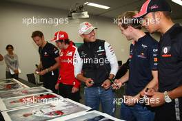 07.10.2011 Suzuka, Japan, The 5 world champions with signed photos commissioned by Bernie Ecclestone (GBR) to then be put up for auction to raise money for the Japanese disaster, Fernando Alonso (ESP), Scuderia Ferrari with Sebastian Vettel (GER), Red Bull Racing, Lewis Hamilton (GBR), McLaren Mercedes and Michael Schumacher (GER), Mercedes GP Petronas F1 Team  - Formula 1 World Championship, Rd 15, Japanese Grand Prix, Friday Practice