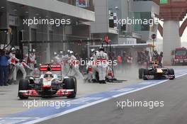 16.10.2011 Yeongam, Korea, Lewis Hamilton (GBR), McLaren Mercedes beats Mark Webber (AUS), Red Bull Racing in the pit stop  - Formula 1 World Championship, Rd 16, Korean Grand Prix, Sunday Race