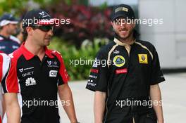 08.04.2011 Sepang, Malaysia,  Timo Glock (GER), Marussia Virgin Racing with Nick Heidfeld (GER), Lotus Renault GP - Formula 1 World Championship, Rd 02, Malaysian Grand Prix, Friday
