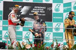 10.04.2011 Sepang, Malaysia,  Jenson Button (GBR), McLaren Mercedes, 1st place Sebastian Vettel (GER), Red Bull Racing and 3rd place Nick Heidfeld (GER), Lotus Renault GP - Formula 1 World Championship, Rd 02, Malaysian Grand Prix, Sunday Podium