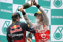 10.04.2011 Sepang, Malaysia,  Sebastian Vettel (GER), Red Bull Racing and Jenson Button (GBR), McLaren Mercedes  - Formula 1 World Championship, Rd 02, Malaysian Grand Prix, Sunday Podium