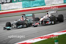 10.04.2011 Sepang, Malaysia,  Michael Schumacher (GER), Mercedes GP Petronas F1 Team and Kamui Kobayashi (JAP), Sauber F1 Team - Formula 1 World Championship, Rd 02, Malaysian Grand Prix, Sunday Race