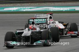 10.04.2011 Sepang, Malaysia,  Michael Schumacher (GER), Mercedes GP and Kamui Kobayashi (JAP), Sauber F1 Team  - Formula 1 World Championship, Rd 02, Malaysian Grand Prix, Sunday Race