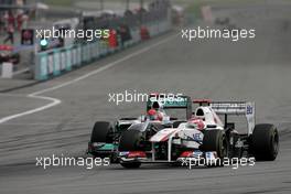 10.04.2011 Sepang, Malaysia,  Kamui Kobayashi (JAP), Sauber F1 Team and Michael Schumacher (GER), Mercedes GP  - Formula 1 World Championship, Rd 02, Malaysian Grand Prix, Sunday Race