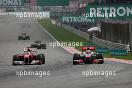 10.04.2011 Sepang, Malaysia,  Fernando Alonso (ESP), Scuderia Ferrari and Jenson Button (GBR), McLaren Mercedes  - Formula 1 World Championship, Rd 02, Malaysian Grand Prix, Sunday Race