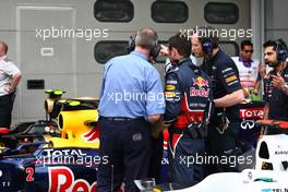 09.04.2011 Sepang, Malaysia,  FIA talking with the mechanicsfrom Red Bull overr the car of Sebastian Vettel (GER), Red Bull Racing - Formula 1 World Championship, Rd 02, Malaysian Grand Prix, Saturday Qualifying