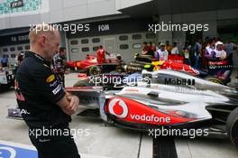 09.04.2011 Sepang, Malaysia,  Adrian Newey (GBR), Red Bull Racing, Technical Operations Director looking at the McLaren - Formula 1 World Championship, Rd 02, Malaysian Grand Prix, Saturday Qualifying