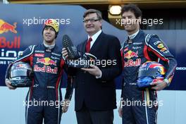 01.02.2011 Valencia, Spain,  Sebastian Vettel (GER) Red Bull Racing with Mark Webber (AUS), Red Bull Racing and a representative of GEOX - Red Bull Racing RB7 Launch - Formula 1 World Championship