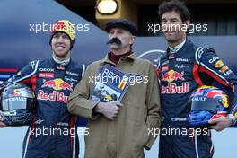 01.02.2011 Valencia, Spain,  Sebastian Vettel (GER) Red Bull Racing and Mark Webber (AUS) Red Bull Racing with a Haynes manual mechanic - Red Bull Racing RB7 Launch - Formula 1 World Championship