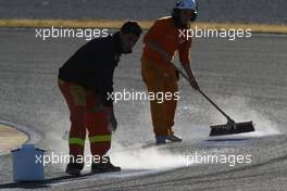 03.02.2011 Valencia, Spain,  People cleaning the track after Felipe Massa (BRA), Scuderia Ferrari blows up his engine  - Formula 1 Testing - Formula 1 World Championship 2011
