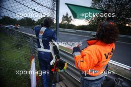 A marshal waving the green flag after a crash 19.05.2012. ADAC Zurich 24 Hours, Nurburgring, Germany