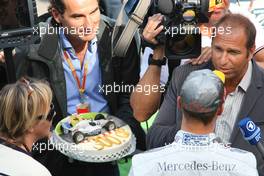 Michael Schumacher (GER), Mercedes GP gets a cake to his 300th race from RTL 02.09.2012. Formula 1 World Championship, Rd 12, Belgian Grand Prix, Spa Francorchamps, Belgium, Race Day