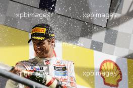 Race winner Jenson Button (GBR) McLaren celebrates on the podium. 02.09.2012. Formula 1 World Championship, Rd 12, Belgian Grand Prix, Spa Francorchamps, Belgium, Race Day