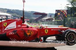 The Ferrari F2012 of Fernando Alonso (ESP) Ferrari is craned away after a crash at the start of the race. 02.09.2012. Formula 1 World Championship, Rd 12, Belgian Grand Prix, Spa Francorchamps, Belgium, Race Day