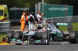 Michael Schumacher (GER) Mercedes AMG F1 W03 and Kimi Raikkonen (FIN) Lotus F1 E20 battle for position. 02.09.2012. Formula 1 World Championship, Rd 12, Belgian Grand Prix, Spa Francorchamps, Belgium, Race Day