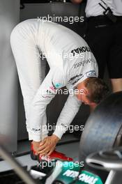 Michael Schumacher (GER) Mercedes AMG F1 stretches before the start of the first practice session. 20.04.2012. Formula 1 World Championship, Rd 4, Bahrain Grand Prix, Sakhir, Bahrain, Practice Day