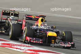 Sebastian Vettel (GER) Red Bull Racing RB8 leads Kimi Raikkonen (FIN) Lotus E20. 20.04.2012. Formula 1 World Championship, Rd 4, Bahrain Grand Prix, Sakhir, Bahrain, Practice Day