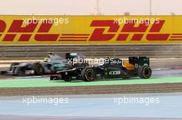 Nico Rosberg (GER) Mercedes AMG F1 W03 and Vitaly Petrov (RUS) Caterham F1 Team CT01  20.04.2012. Formula 1 World Championship, Rd 4, Bahrain Grand Prix, Sakhir, Bahrain, Practice Day
