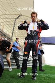 Sebastian Vettel (GER) Red Bull Racing on the grid. Motor Racing - Formula One World Championship - Bahrain Grand Prix - Race Day - Sakhir, Bahrain