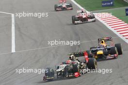 Romain Grosjean (FRA) Lotus F1 E20 leads Mark Webber (AUS) Red Bull Racing RB8. Motor Racing - Formula One World Championship - Bahrain Grand Prix - Race Day - Sakhir, Bahrain