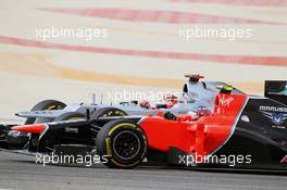 Charles Pic (FRA) Marussia F1 Team MR01 and Michael Schumacher (GER) Mercedes AMG F1 W03 battle for position. Motor Racing - Formula One World Championship - Bahrain Grand Prix - Race Day - Sakhir, Bahrain