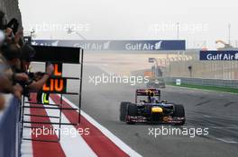 Race winner Sebastian Vettel (GER) Red Bull Racing RB8 celebrates past his team at the end of the race. Motor Racing - Formula One World Championship - Bahrain Grand Prix - Race Day - Sakhir, Bahrain