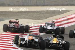 Daniel Ricciardo (AUS) Scuderia Toro Rosso STR7 and Pastor Maldonado (VEN) Williams FW34 leads Nico Hulkenberg (GER) Sahara Force India F1 VJM05 and Vitaly Petrov (RUS) Caterham CT01. Motor Racing - Formula One World Championship - Bahrain Grand Prix - Race Day - Sakhir, Bahrain