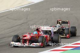 Fernando Alonso (ESP) Ferrari F2012 leads Kimi Raikkonen (FIN) Lotus E20. Motor Racing - Formula One World Championship - Bahrain Grand Prix - Race Day - Sakhir, Bahrain