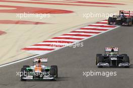 Nico Hulkenberg (GER) Sahara Force India F1 VJM05 leads Bruno Senna (BRA) Williams FW34. Motor Racing - Formula One World Championship - Bahrain Grand Prix - Race Day - Sakhir, Bahrain