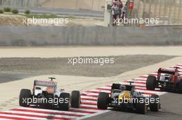 Vitaly Petrov (RUS) Caterham CT01 and Nico Hulkenberg (GER) Sahara Force India F1 VJM05. Motor Racing - Formula One World Championship - Bahrain Grand Prix - Race Day - Sakhir, Bahrain