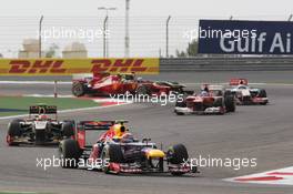 Mark Webber (AUS) Red Bull Racing RB8 leads Romain Grosjean (FRA) Lotus F1 E20. Motor Racing - Formula One World Championship - Bahrain Grand Prix - Race Day - Sakhir, Bahrain