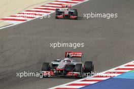 Jenson Button (GBR) McLaren MP4/27 leads Lewis Hamilton (GBR) McLaren MP4/27. Motor Racing - Formula One World Championship - Bahrain Grand Prix - Race Day - Sakhir, Bahrain