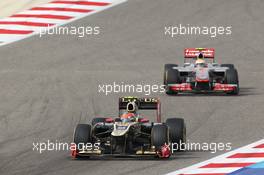 Romain Grosjean (FRA) Lotus F1 E20 leads Lewis Hamilton (GBR) McLaren MP4/27. Motor Racing - Formula One World Championship - Bahrain Grand Prix - Race Day - Sakhir, Bahrain