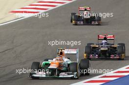 Nico Hulkenberg (GER) Sahara Force India F1 VJM05 leads Daniel Ricciardo (AUS) Scuderia Toro Rosso STR7. Motor Racing - Formula One World Championship - Bahrain Grand Prix - Race Day - Sakhir, Bahrain