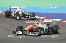 Nico Hulkenberg (GER) Sahara Force India F1 VJM05 leads Kamui Kobayashi (JPN) Sauber C31. Motor Racing - Formula One World Championship - Bahrain Grand Prix - Race Day - Sakhir, Bahrain