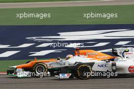 Paul di Resta (GBR) Sahara Force India VJM05 and Sergio Perez (MEX) Sauber C31 battle for position. Motor Racing - Formula One World Championship - Bahrain Grand Prix - Race Day - Sakhir, Bahrain