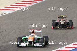 Paul di Resta (GBR) Sahara Force India VJM05 leads Romain Grosjean (FRA) Lotus F1 E20. Motor Racing - Formula One World Championship - Bahrain Grand Prix - Race Day - Sakhir, Bahrain