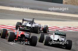 Charles Pic (FRA) Marussia F1 Team MR01 and Michael Schumacher (GER) Mercedes AMG F1 W03 battle for position. Motor Racing - Formula One World Championship - Bahrain Grand Prix - Race Day - Sakhir, Bahrain