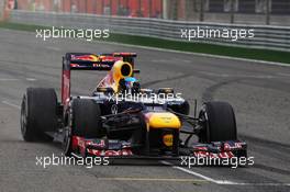 Race winner Sebastian Vettel (GER) Red Bull Racing RB8 celebrates past his team at the end of the race. Motor Racing - Formula One World Championship - Bahrain Grand Prix - Race Day - Sakhir, Bahrain