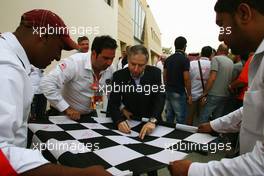 Jean Todt (FRA) FIA President signs autographs for the fans. Motor Racing - Formula One World Championship - Bahrain Grand Prix - Race Day - Sakhir, Bahrain