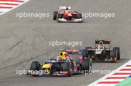 Mark Webber (AUS) Red Bull Racing RB8 leads Romain Grosjean (FRA) Lotus F1 E20. Motor Racing - Formula One World Championship - Bahrain Grand Prix - Race Day - Sakhir, Bahrain