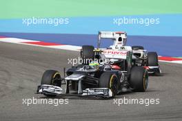 Bruno Senna (BRA) Williams FW34 leads Kamui Kobayashi (JPN) Sauber C31. Motor Racing - Formula One World Championship - Bahrain Grand Prix - Race Day - Sakhir, Bahrain